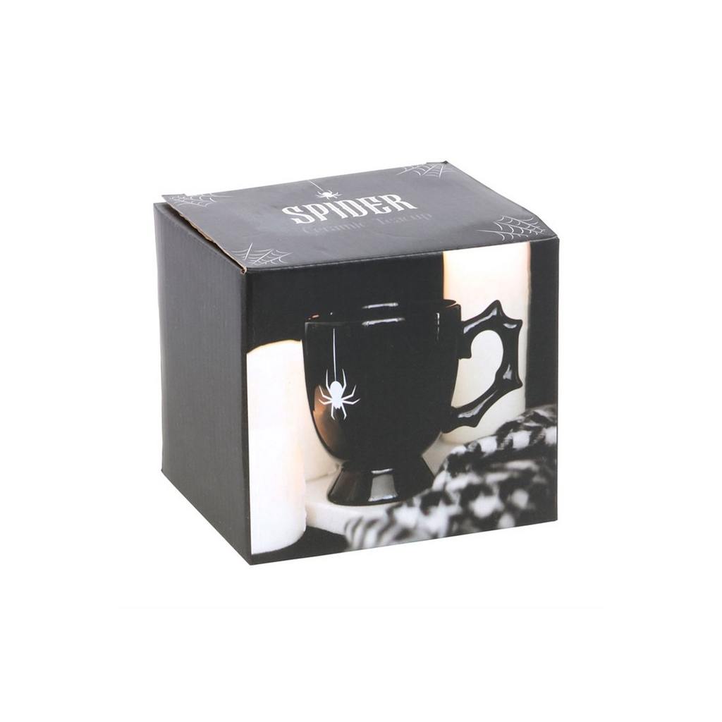 Black mug with spider design in a branded box on a white background