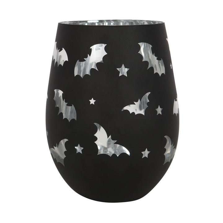 Black stemless wine glass with white bat and star pattern on a white background