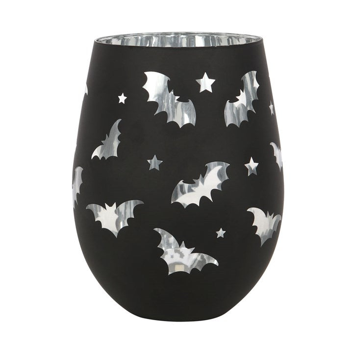 Black wine glass with silver bat and star pattern on a white background