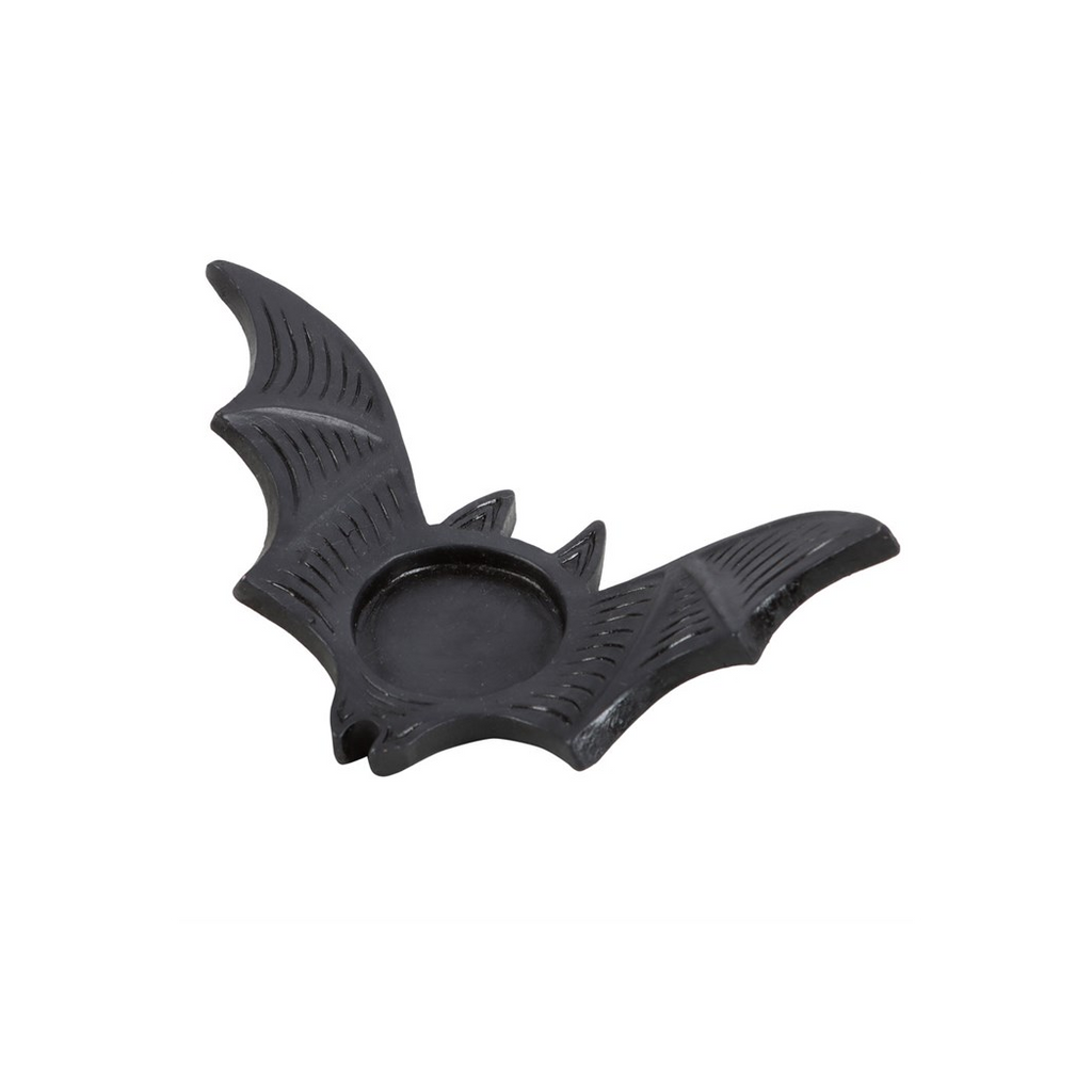 Black bat-shaped candle holder on a white background