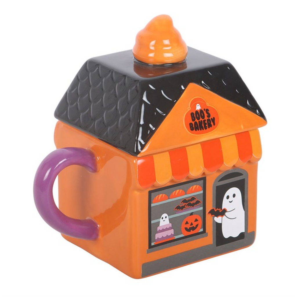 Halloween-themed mug shaped like a bakery with a purple handle on a white background