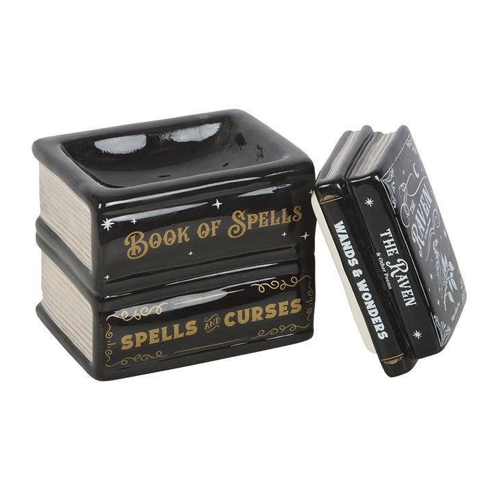 Black and gold decorative book-shaped container with 'Book of Spells' text on a white background