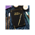 Black notebook titled 'Book of Shadows' with a pen on a dark fabric background
