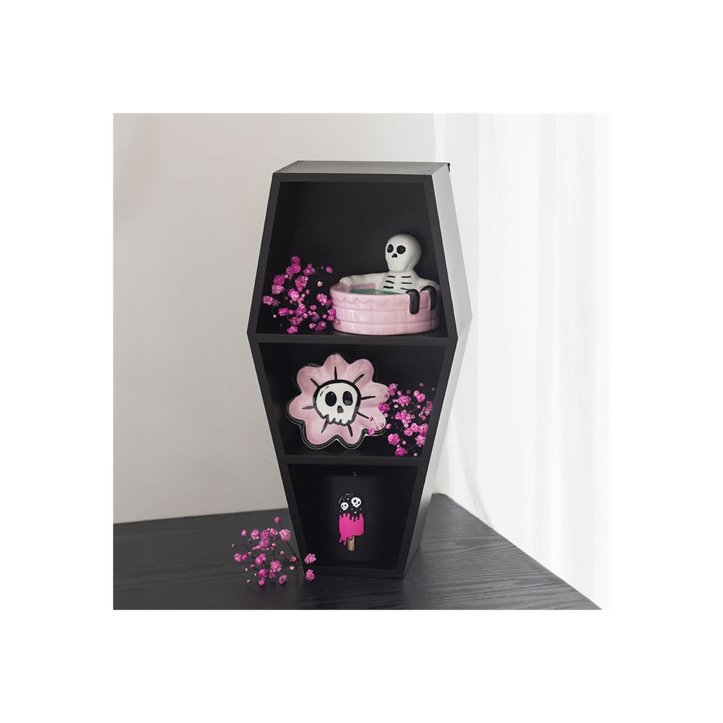 Black hexagonal shelf with decorative items including a skull and pink flower design.