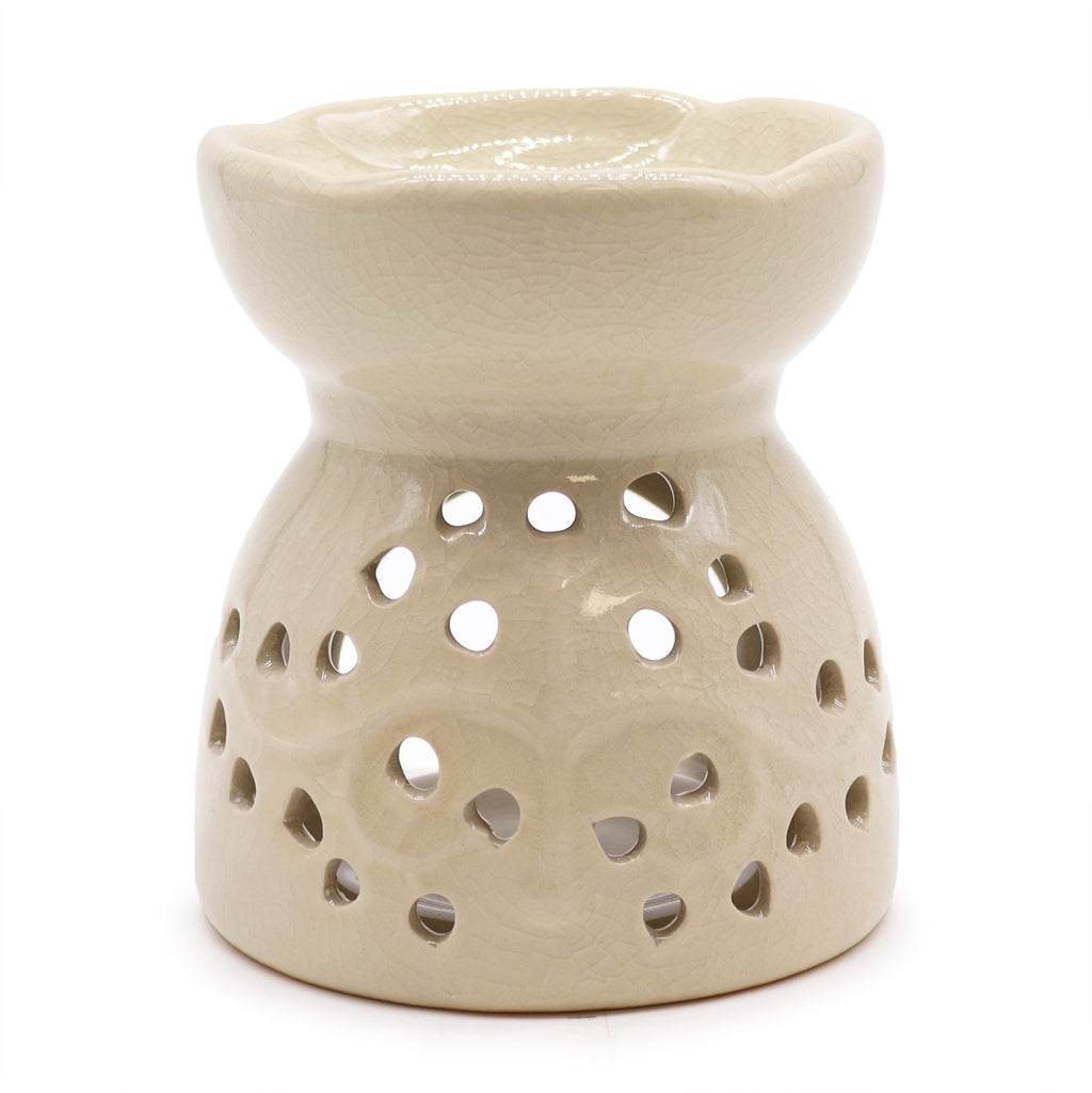 Beige ceramic oil burner with perforated design on a white background