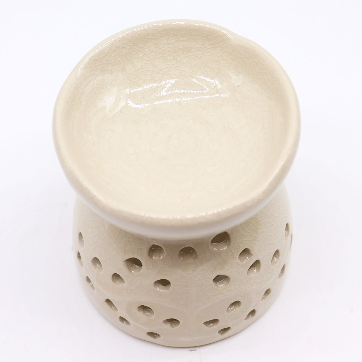 Beige ceramic diffuser with perforated design on a white background