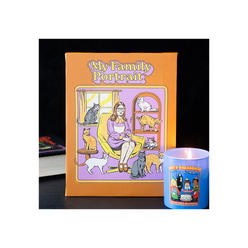 Book titled 'My Family Portrait' with a colorful cover featuring a woman and cats, next to a blue candle.