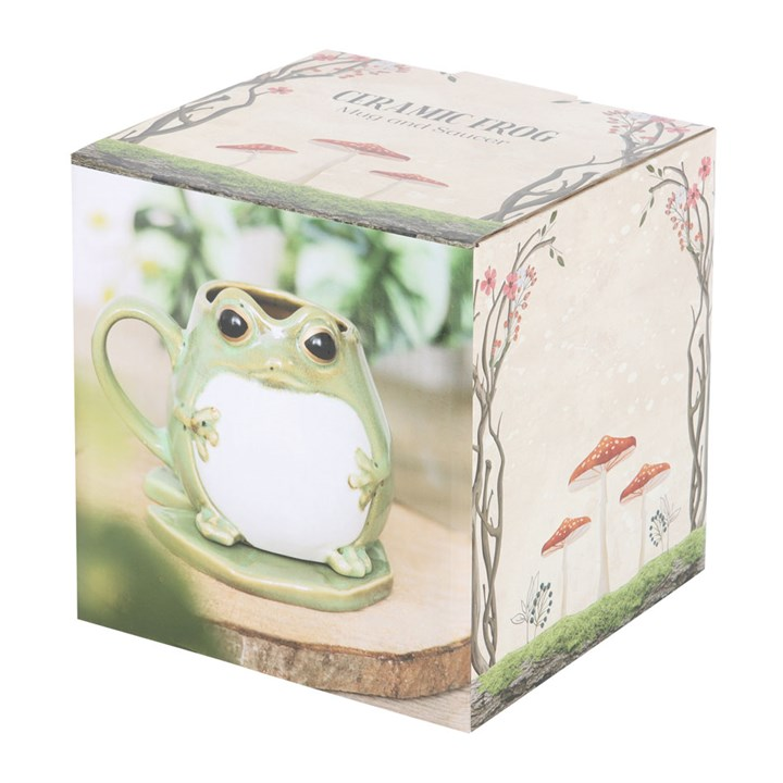 Ceramic frog figurine in packaging with nature-themed design