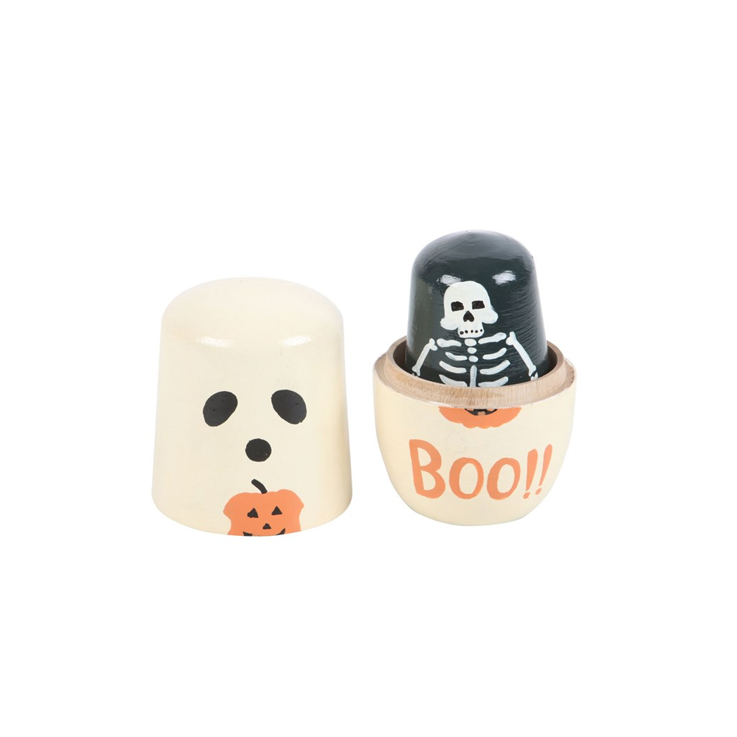 Two Halloween-themed wooden toys, one with a ghost face and the other with a skeleton, on a white background.