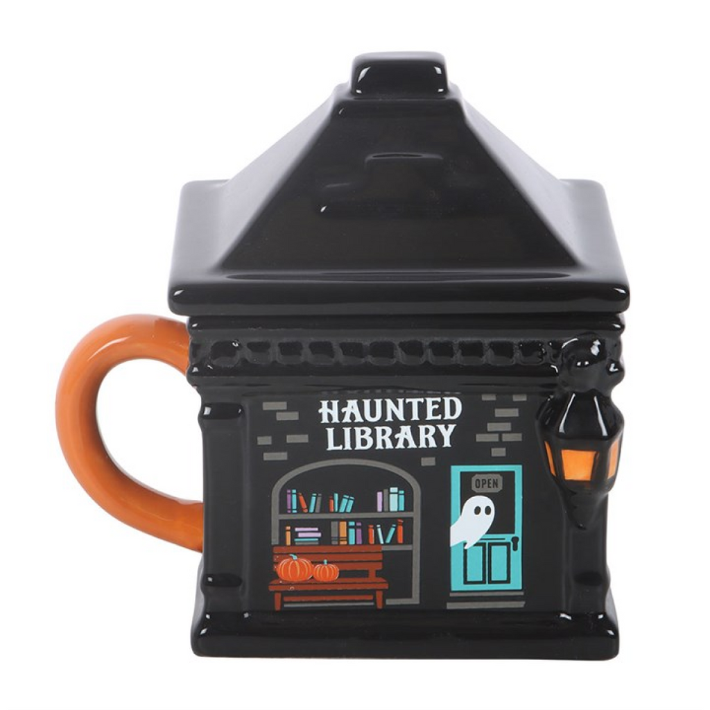 Black haunted library mug with an orange handle on a white background