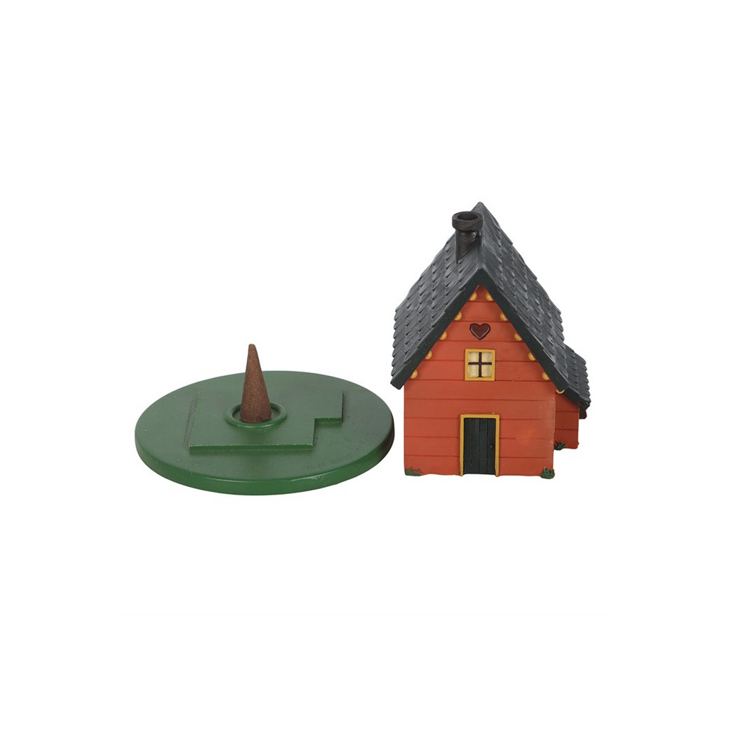 Small model of a house with a green base on a white background