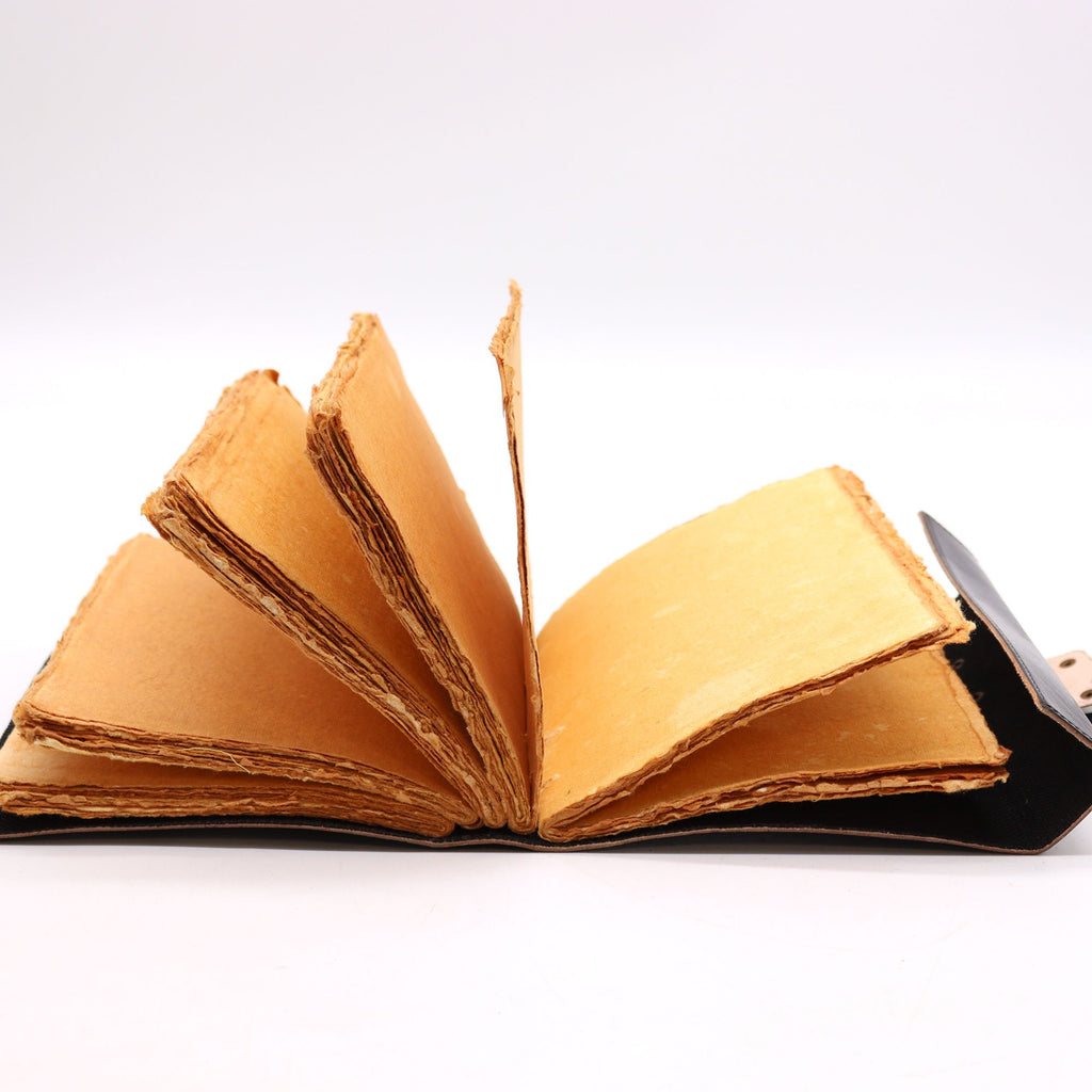 Open book with yellowed pages on a white background