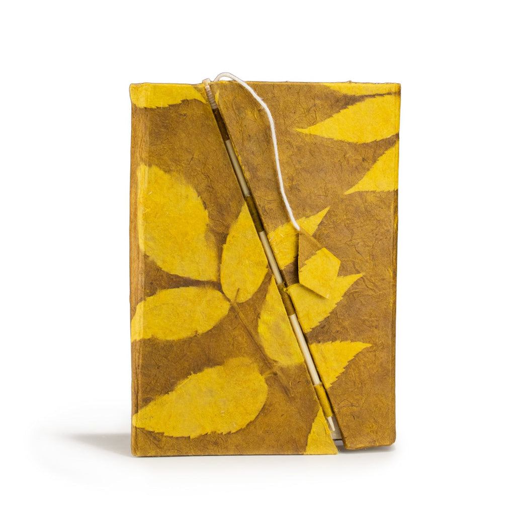 Notebook with yellow leaf pattern on a white background