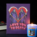 Purple book with Grim Reaper illustration and 'Love You to Death' text, next to a lit candle.