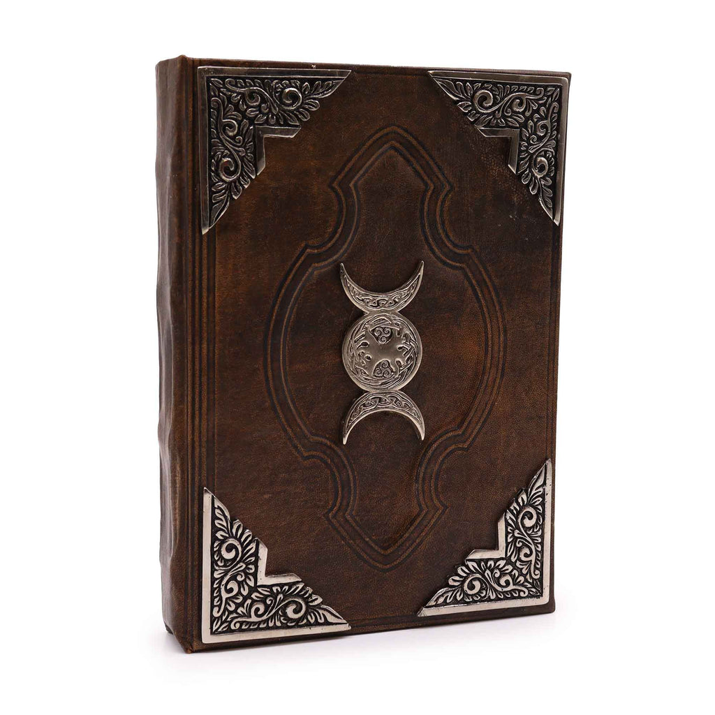 Decorative leather book with metallic emblem on a white background