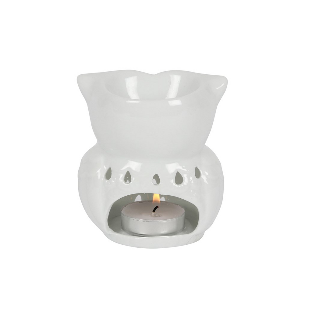 A white ceramic tea light candle warmer with a small lit tealight candle inside, shown against a plain white background.