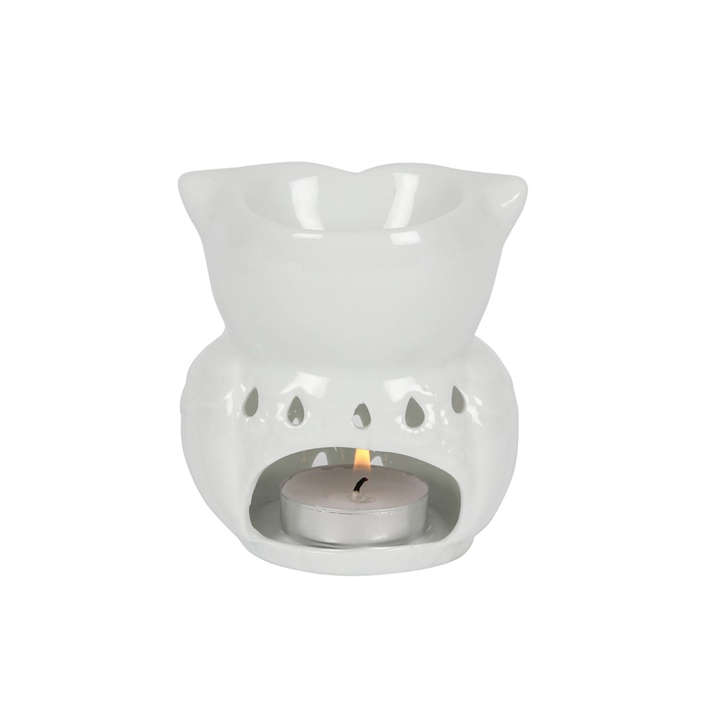 A white ceramic tea light candle warmer with a small lit tealight candle inside, shown against a plain white background.