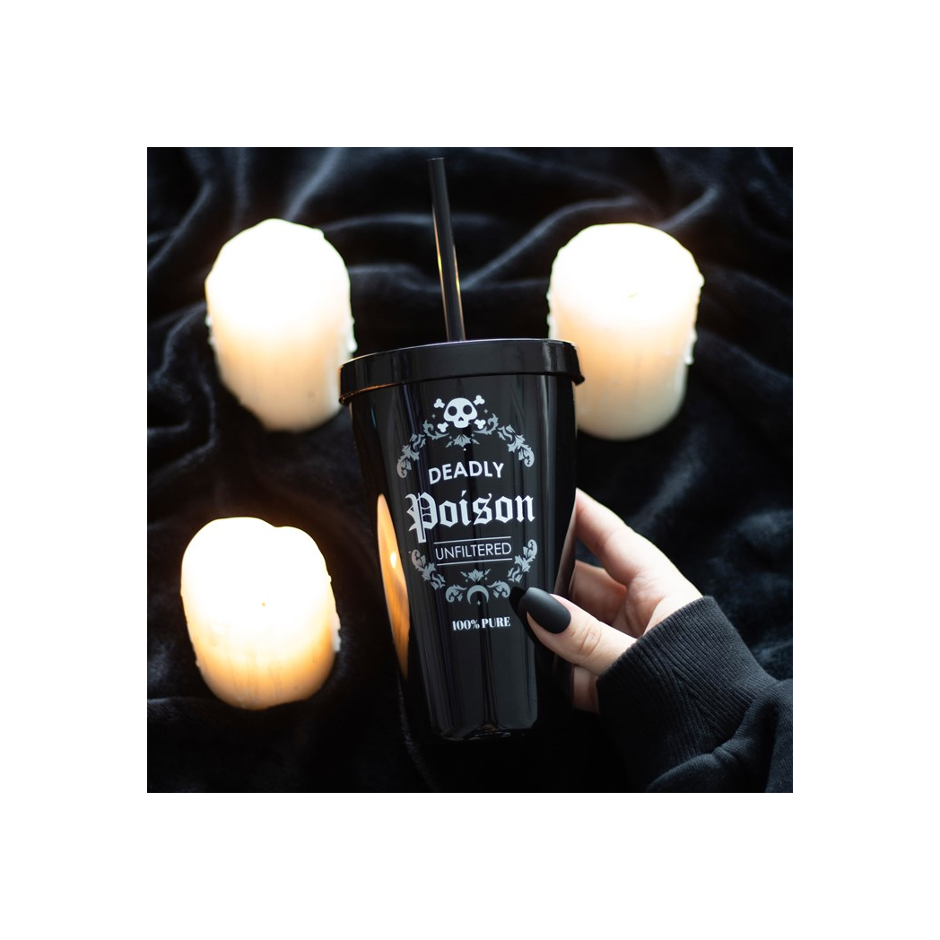 Black cup labeled 'Deadly Poison' held by a hand with candles in the background