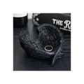 Black decorative angel wing dish with a ring on a dark surface