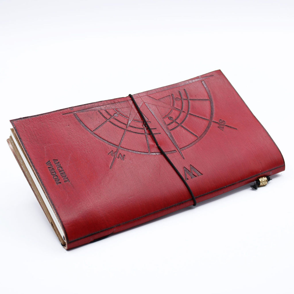 Red leather notebook with engraved design on a white background
