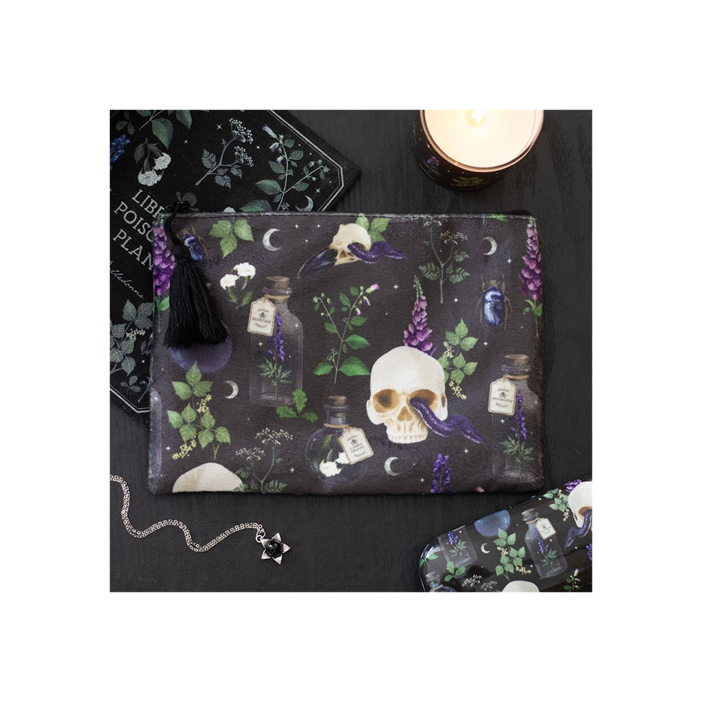 Dark pouch with skull and potion bottle design on a black surface