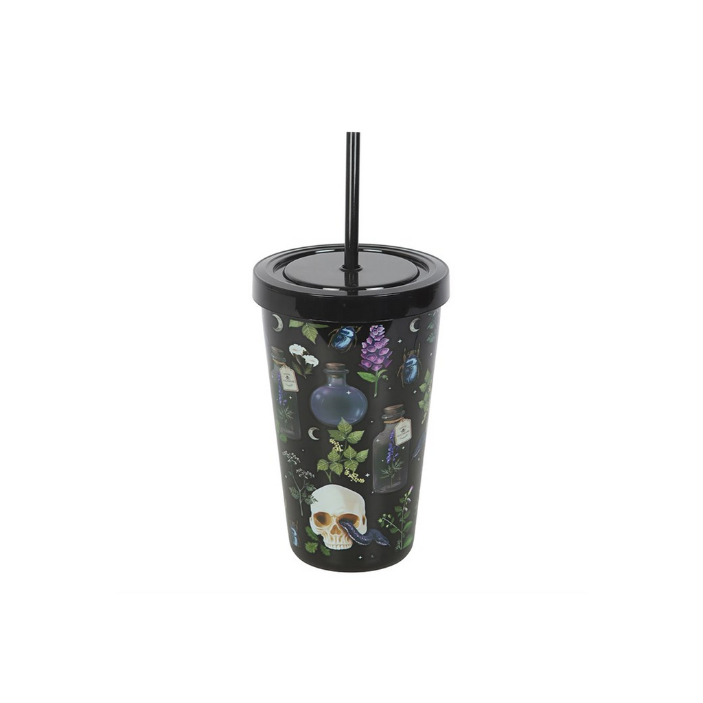 A black insulated tumbler with a matching black lid and straw, decorated with a witch-themed pattern featuring a skull, potion bottles, green leaves, and purple flowers on a white background.