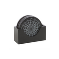 Set of black coasters with spider web design in a holder on a white background