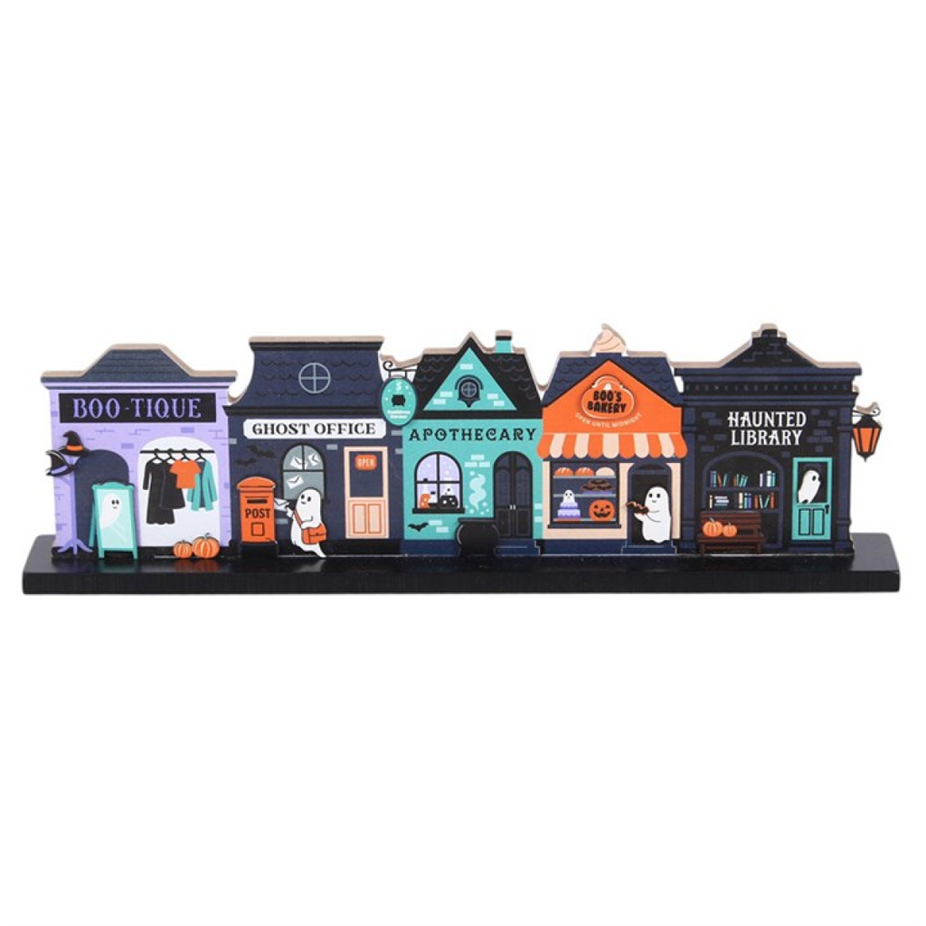 Model of Halloween-themed shops with colorful facades on a white background