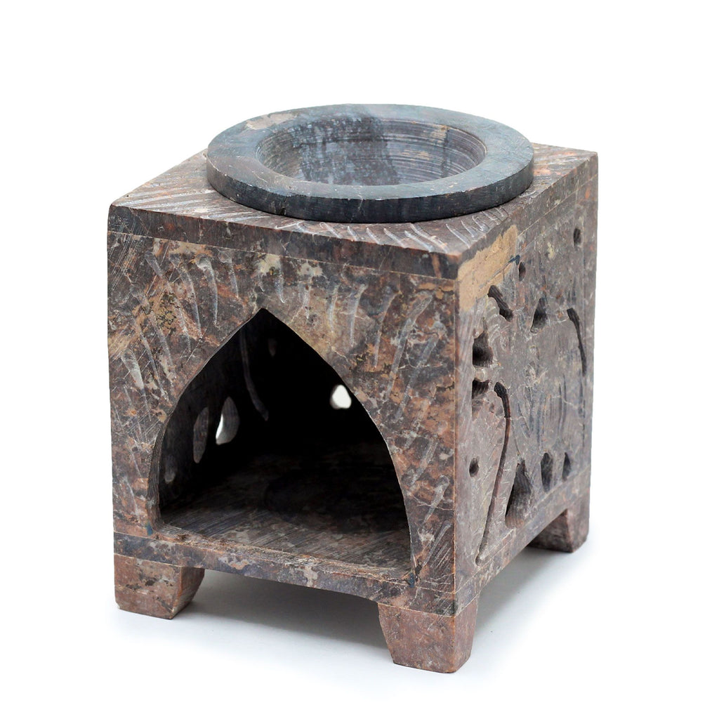 Square stone wax melter with a circular top and geometric design on a white background