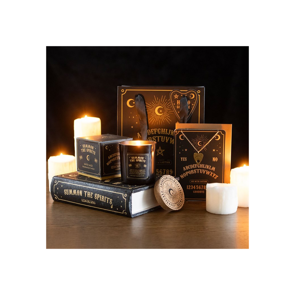 Decorative set with candles and books on a wooden surface, evoking a mystical or vintage atmosphere.